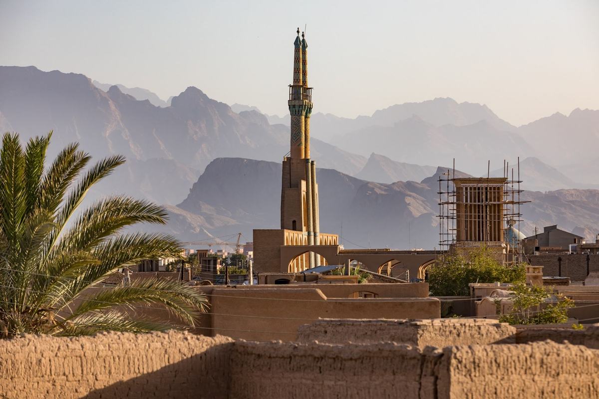 View from the roofs of the old city to a minaret, a windcatcher and the mountains